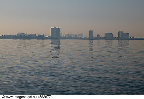 Emeryville city skyline reflected in bay during wildfire season