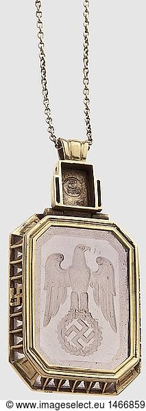 Emmy GÃ¶ring (1893 - 1973)  a gold chain with pendant and national eagle Yellow gold with set semi-precious stone. Very well-executed jeweller's work with '750' mark of fineness and 'DGW' for (tr) 'German Artistic Goldsmith Workshops Berlin-W'. The semi-precious stone in an octagonal gold setting  a lateral decorative band with two swastikas. The ring holder with ash leaf on a hinged band with jewellerÃ¯s mark on the reverse. Dimensions 21.8 x 41.3 x 6.8 mm. The gold chain punched '585' and 'M' with scratched mark (49357?) on the safety closure. Length 42.5 cm. An outstandingly produced piece of jewellery from the DG Workshops in Berlin. It was appropriated in 1945 by de la RoyÃ¨re  an officer in the French 2nd armoured division  historic  historical  1930s  20th century  NS  National Socialism  Nazism  Third Reich  German Reich  Germany  German  National Socialist  Nazi  Nazi period  fascism  jewellery  jewelry  noble  precious  object  objects  stills  clipping  clippings  cut out  cut-out  cut-outs