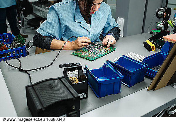 employee working in a factory on her desk