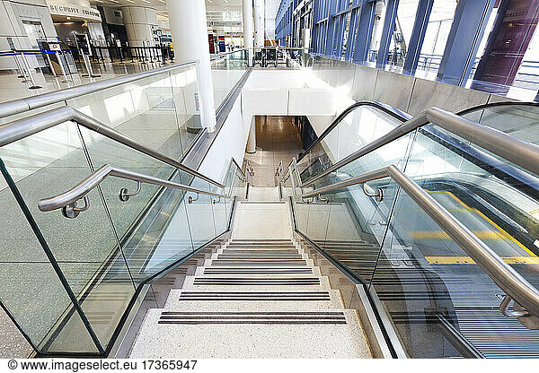 Empty airport interior  concourse and stairs and escalators