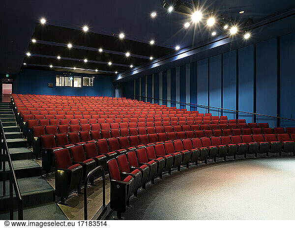Empty auditorium  rows of raked seats.
