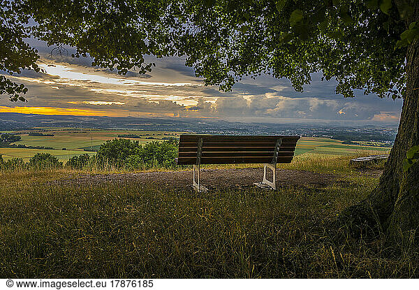Empty bench on land at sunset Mensfelder Kopf  Hesse  Germany