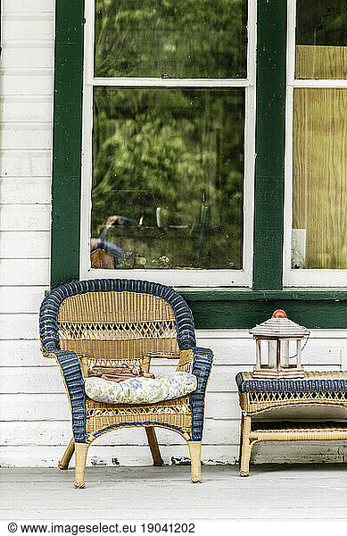 Empty chair and table on a wooden porch.