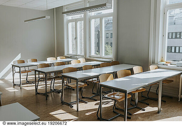 Empty classroom with chairs and desks at school