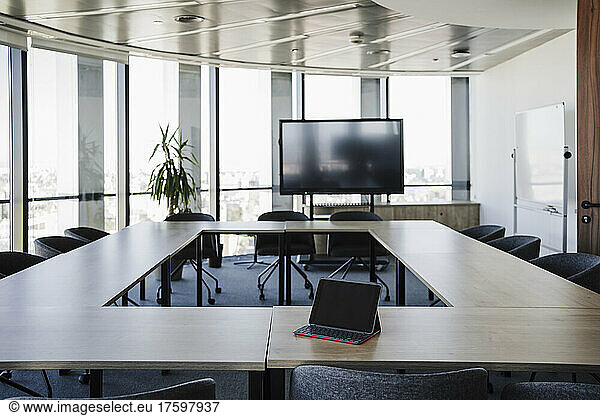 Empty conference room with laptop on table in office