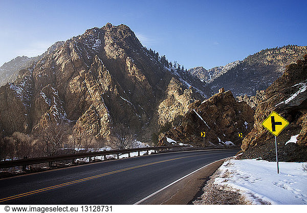 Empty country road by Wasatch Mountains during winter
