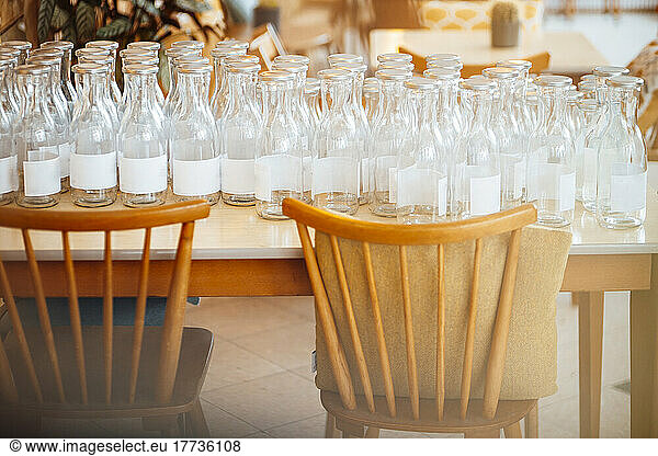 Empty glass bottles on table at cafe