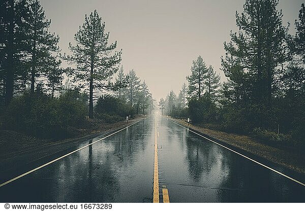 Empty Highway In Rain. Perfect asphalt mountain road in overcast rainy
