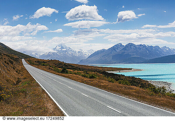 Empty highway stretching along shore of Lake Pukaki