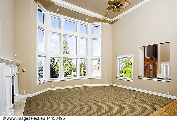 Empty living room with large windows