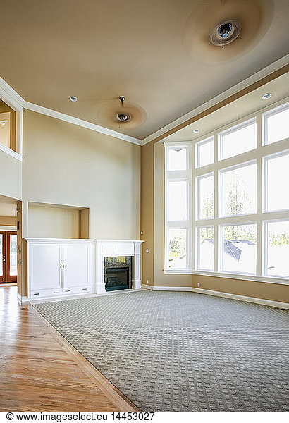 Empty living room with tall windows