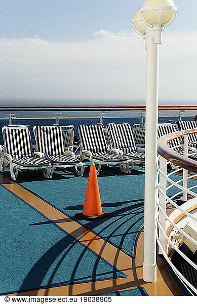 Empty lounge chairs on a cruise ship.