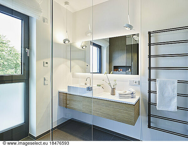 Empty modern bathroom with glass doors in apartment