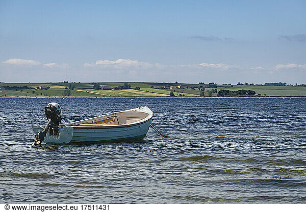 Empty motorboat floating in coastal water