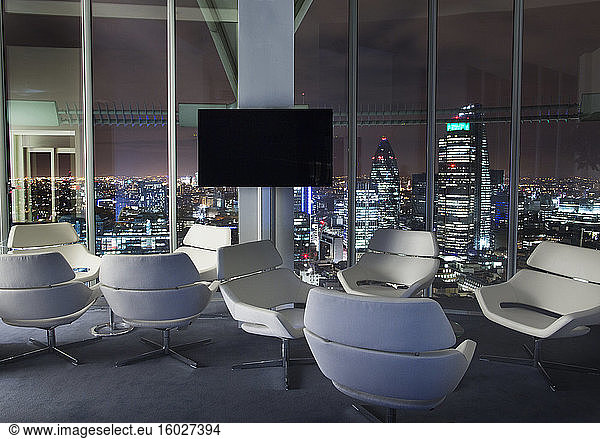 Empty office sitting area overlooking city