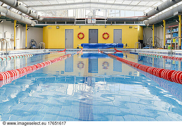 Empty pool with swimmer lanes in blue water