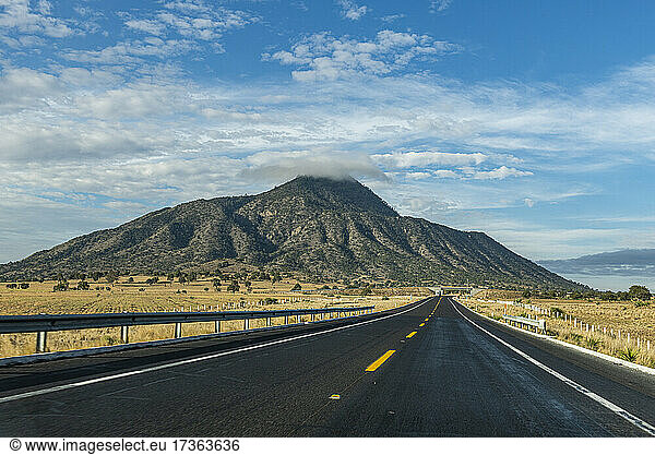 Empty road leading towards El Pizarro volcano  Puebla  Mexico