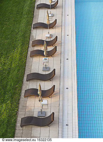 Empty sun loungers at the poolside