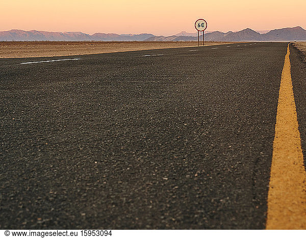 Empty tarmac road in the desert at sunset  Namibia