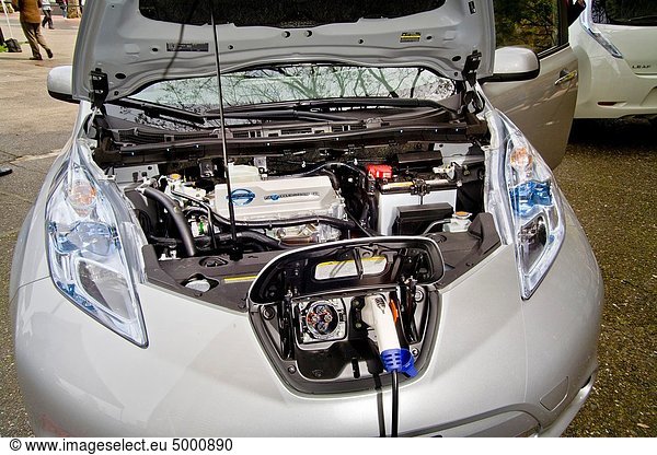 Engine compartment and charging port of the Nissan Leaf  a five-door mid-size hatchback all-electric zero-emissions car introduced in the U S in December 2010 It has a range of 100 miles and economy is 99 miles per gallon gasoline equivalent The car is. Engine compartment and charging port of the Nissan Leaf  a five-door mid-size hatchback all-electric zero-emissions car introduced in the U S in December 2010 It has a range of 100 miles and economy is 99 miles per gallon gasoline equivalent The car is on display in San Francisco´s Embarcadero Center