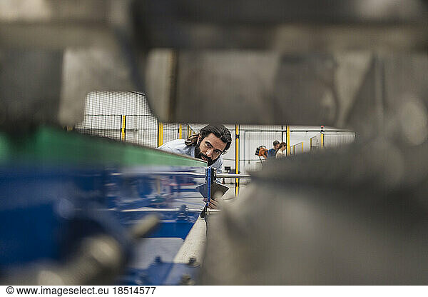 Engineer examining machinery in industry