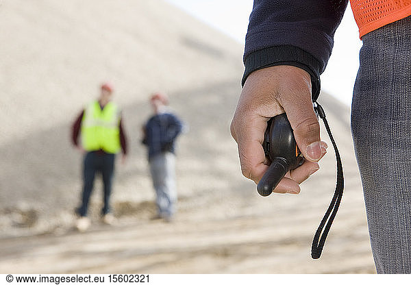 Engineer holding a walkie-talkie
