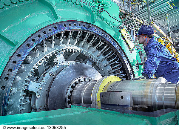 Engineer inspecting generator in nuclear power station during outage