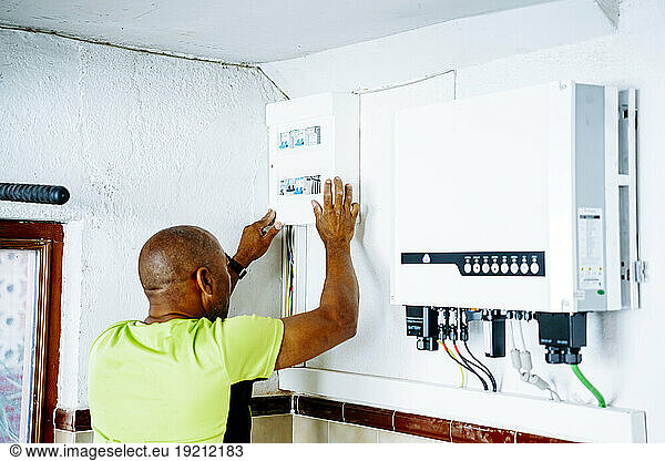 Engineer installing system in utility room