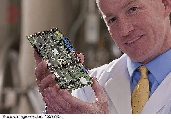 Engineer showing a micro controller circuit board