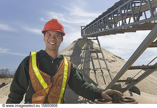 Engineer standing at a gravel and asphalt plant