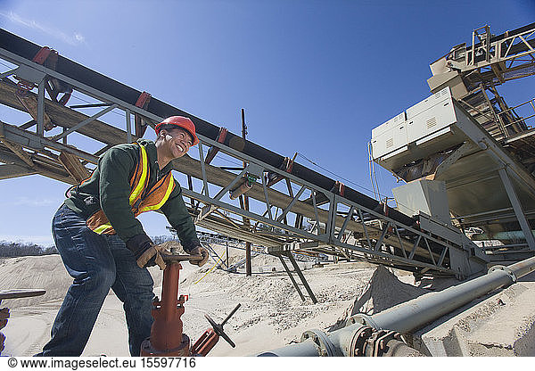 Engineer turning valve at a gravel and asphalt plant