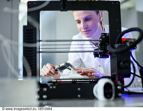 Engineer using vernier calliper operating on 3D printing machine