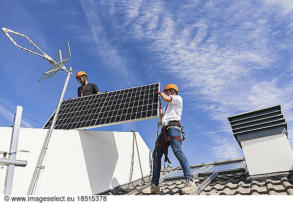 Engineer working on roof with solar panel