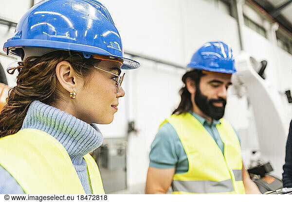 Engineers wearing protective work wear in factory