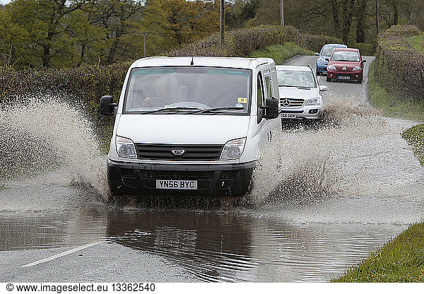 England  Kent  Flooding  Flooded country road with cars driving slowly through waters.