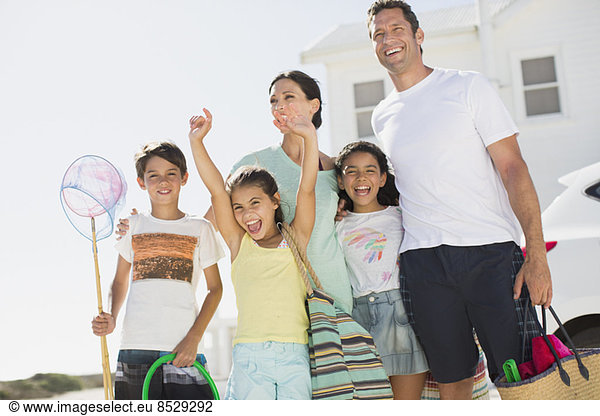 Enthusiastic family with beach gear