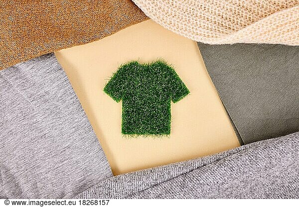 Environmental friendly produced clothing concept with shirt made out of grass surrounded by sweaters