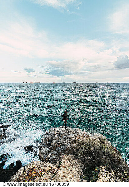 Epic Shot Of A Man In The Center Of A Landscape Facing The Sea