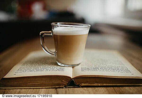 Espresson coffe on old book closeup.