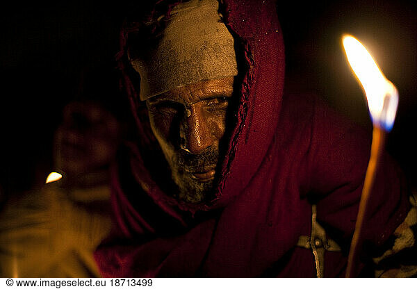 Ethiopian Orthodox man near St. Mary of Zion church during a pre-dawn candlelight procession  Aksum  Northern Ethiopia.