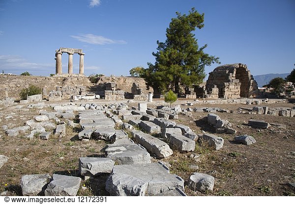 Europe  Greece  Peloponnese  ancient Corinth  archaeological site  view with the north east shops and the Temple of Apollo.