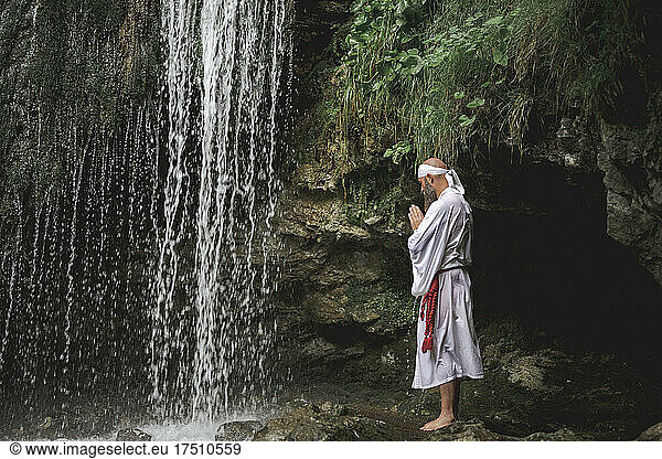 European yamabushi monk doing takigyo waterfall meditation