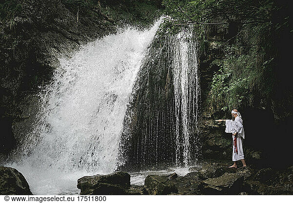 European yamabushi monk doing takigyo waterfall meditation