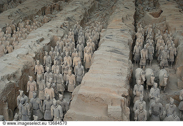 Excavated Tomb of terracotta warriors  Xi'an  China. A full army of terracotta warriors were created to guard the tomb of Quin Shi Huang  the first emperor of China  who died in 210 BC. It was discovered by farmers digging a well in 1974. This is a view of pit #1. It is now a World Heritage site.