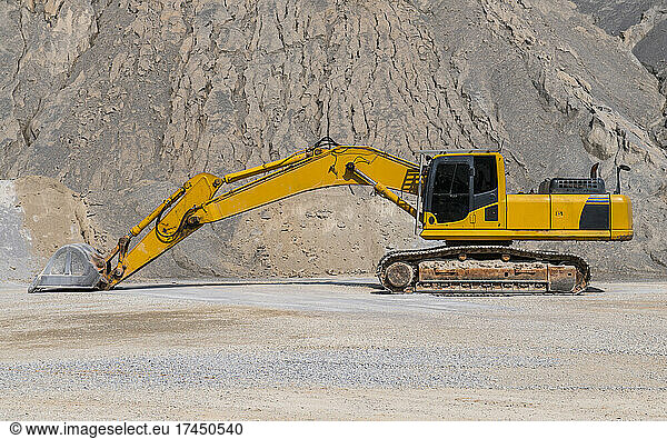 excavator parked at gravel mine in Thailand