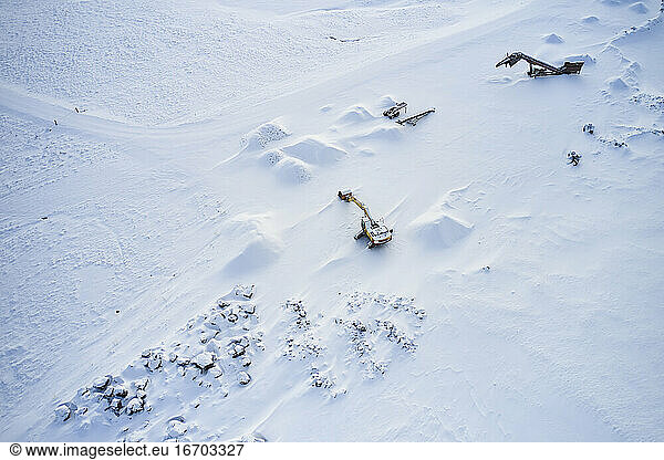 Excavators in mountainous area in winter