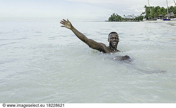 Excited African American man in sea
