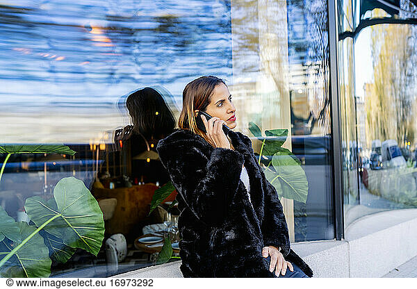 executive woman in the city talking on her smartphone