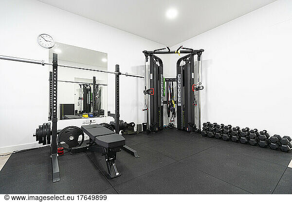 Exercise equipment and dumbbells in empty gym