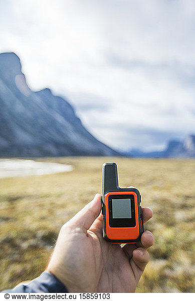 Explorer holding GPS used for navigation and communication.